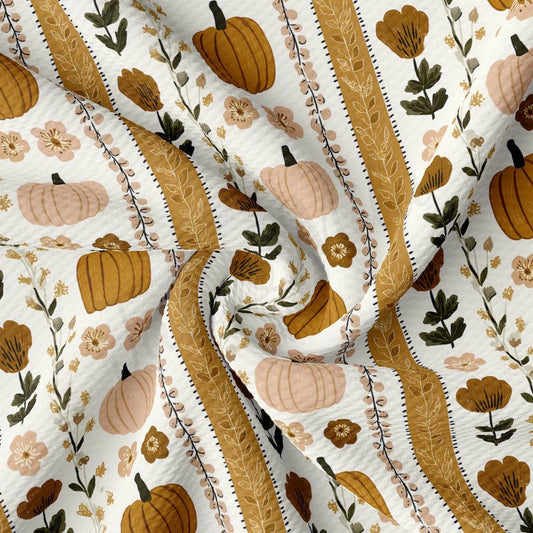 The image is a close-up of a fabric with a repeating pattern of pumpkins and flowers in shades of brown and beige.