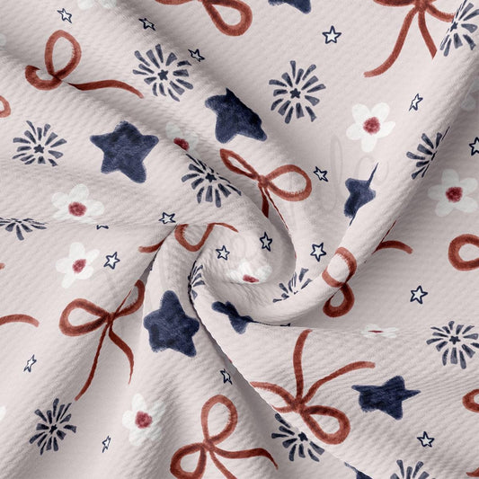 a white fabric with red, white and blue bows