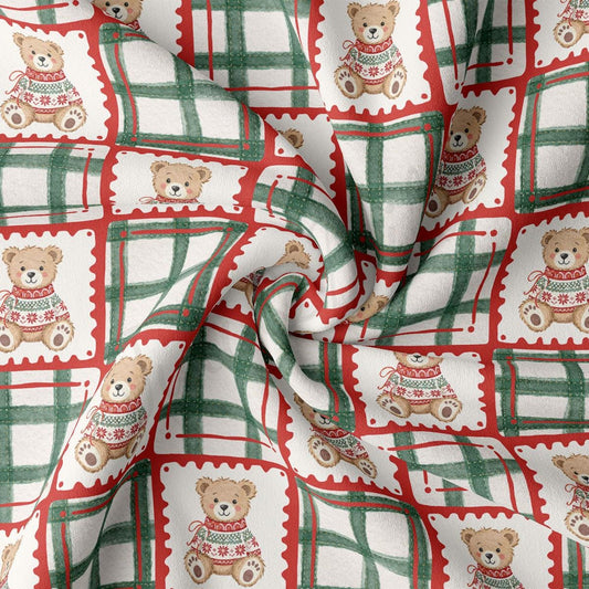 The image is a close-up of a fabric with a repeating pattern of teddy bears wearing sweaters in red and green plaid designs.