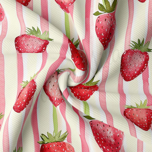 a pink and white striped fabric with strawberries on it