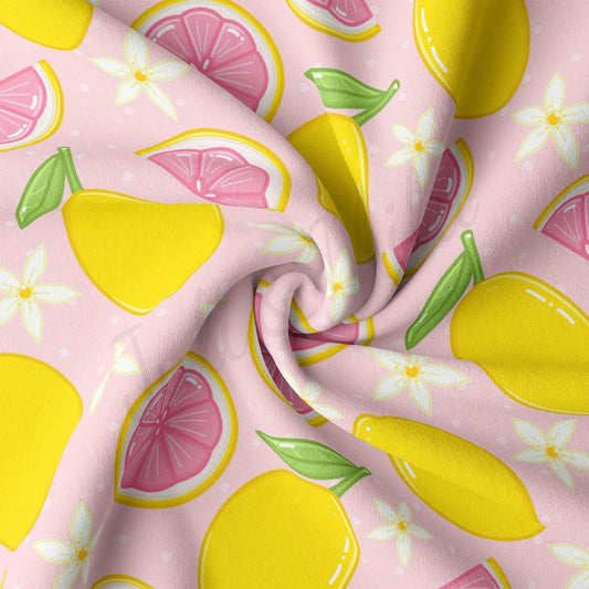 a pink and yellow fabric with lemons on it