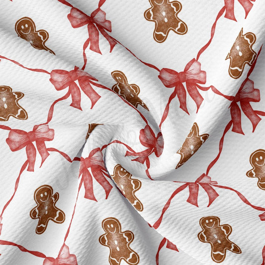 a close up of a red and white fabric with a pattern of gingerbreads