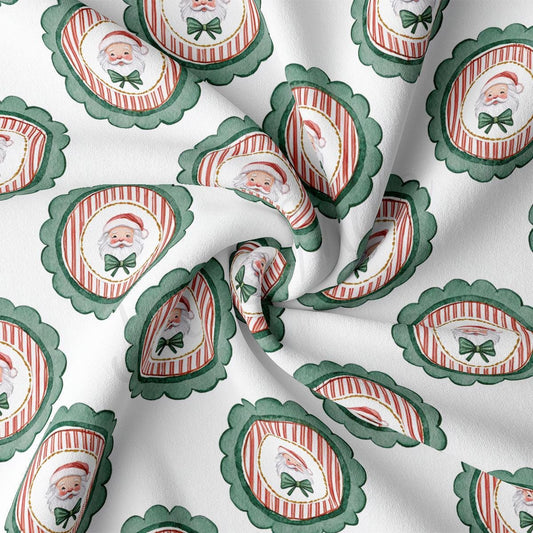 The image is a close-up of a fabric with a repeating pattern of Santa Claus and green bows on a white background.