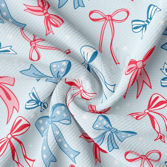 a red, white and blue bow print fabric