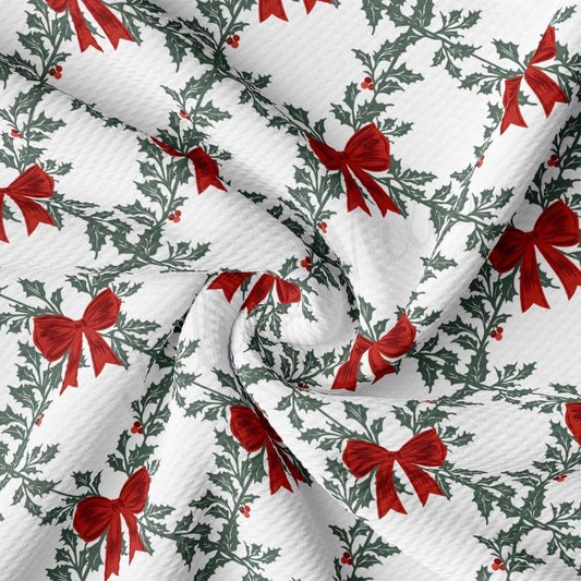 a close-up view of a fabric with a repeating pattern of red bows and green leaves, creating a festive and holiday-themed design.