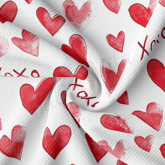 a close-up view of a fabric with a repeating pattern of red hearts on a white background.