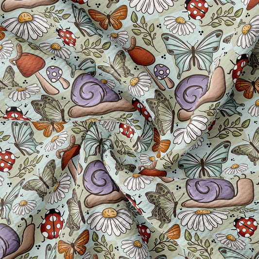 The image is a vibrant and whimsical pattern featuring various insects, flowers, and mushrooms. The pattern includes butterflies, ladybugs, and snails, all set against a light green background. The overall design is playful and full of life, with each element contributing to the overall visual appeal.