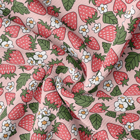 a pink fabric with strawberrys and flowers on it