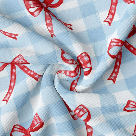 a blue and white checkered fabric with red bows