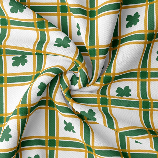 a green and yellow plaid fabric with shamrocks on it