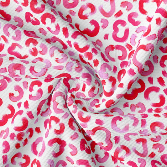 a red and white fabric with red and pink spots