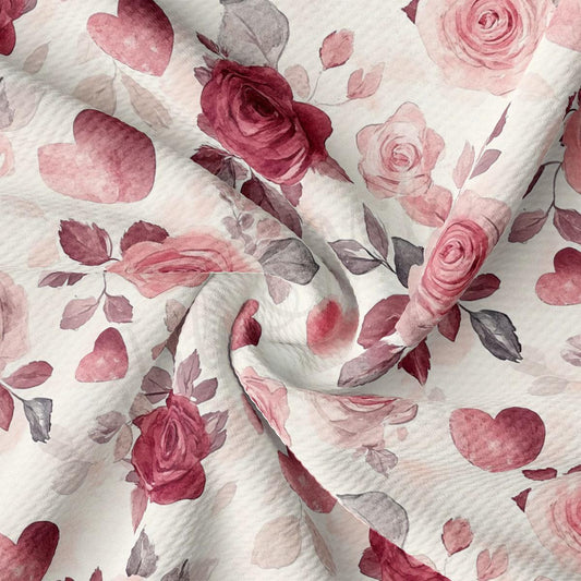 a close-up view of a fabric with a floral pattern of pink roses and hearts.