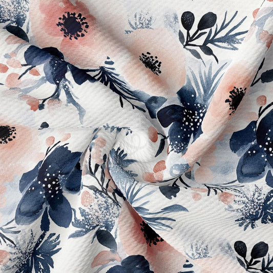 a close-up view of a fabric with a floral pattern in shades of blue, pink, and white. The pattern consists of various flowers and leaves, creating a visually appealing and intricate design.