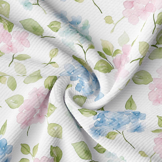a close-up view of a fabric with a floral pattern, featuring various shades of pink, blue, and green flowers and leaves.