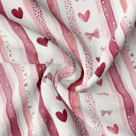 The image is a close-up of a fabric with a repeating pattern of pink and white stripes, along with small red hearts scattered throughout the fabric.