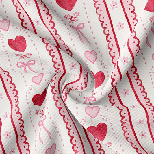 The image is a close-up of a fabric with a repeating pattern of pink hearts and red bows. The fabric appears to be crumpled, giving it a soft and delicate appearance.
