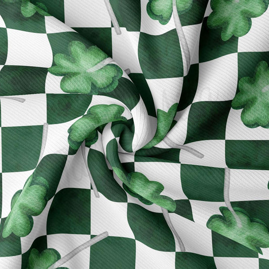 a green and white checkered fabric with shamrocks on it