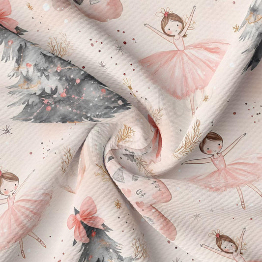 The image is a close-up of a fabric with a repeating pattern of pink and white dancing ballerina figures, along with various decorative elements such as trees and snowflakes.