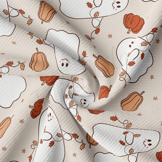 a white fabric with a pattern of pumpkins and ghost