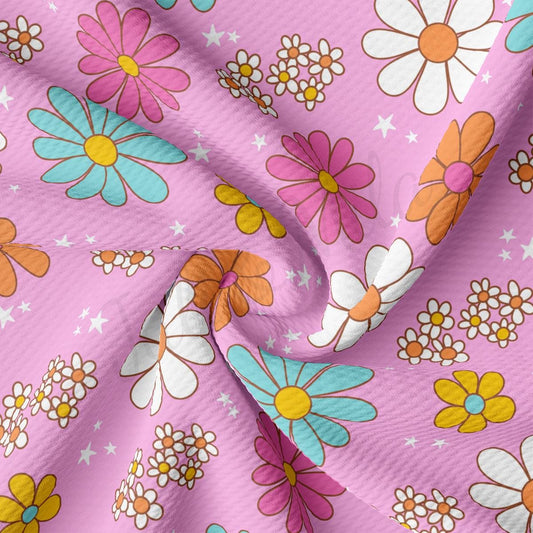 a close up of a pink fabric with flowers on it