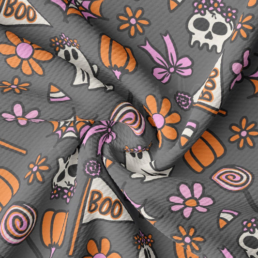 a gray and orange fabric with skulls and flowers