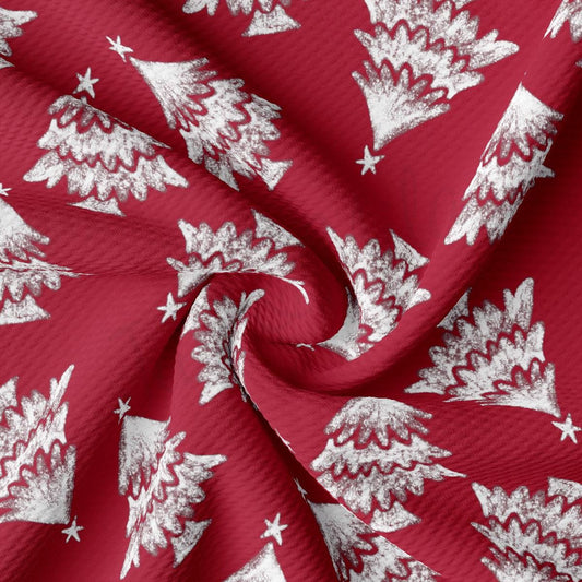 a red fabric with white christmas trees on it