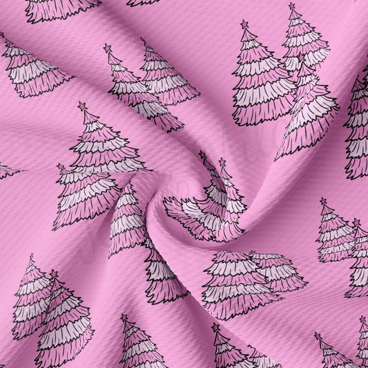 a pink fabric with white trees on it