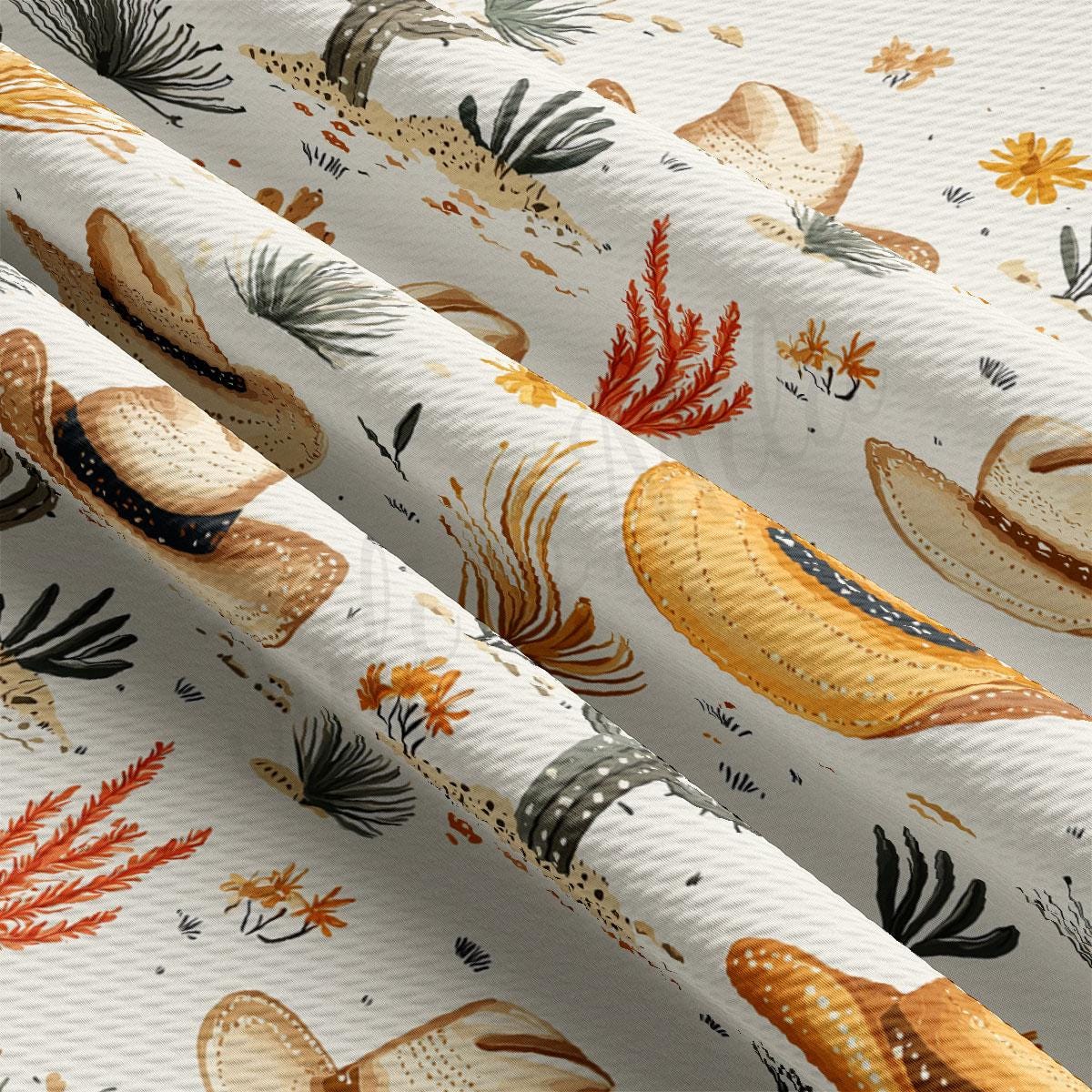 a close-up view of a fabric with a repeating pattern of hats and plants, including straw hats and various types of foliage.