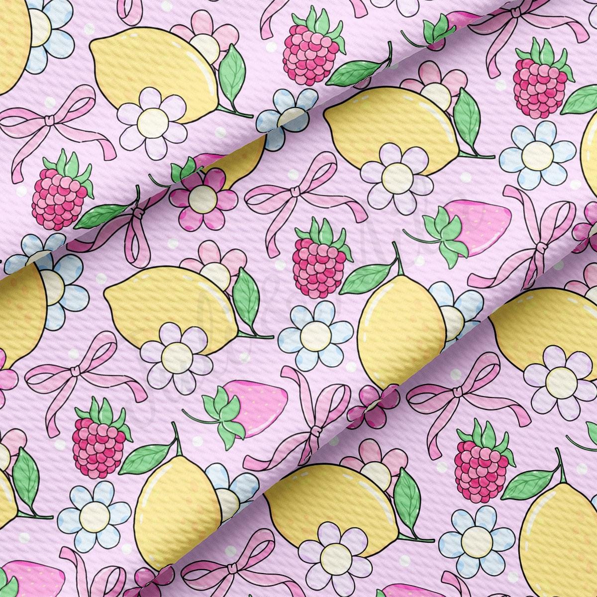 a pink background with lemons, raspberries and flowers