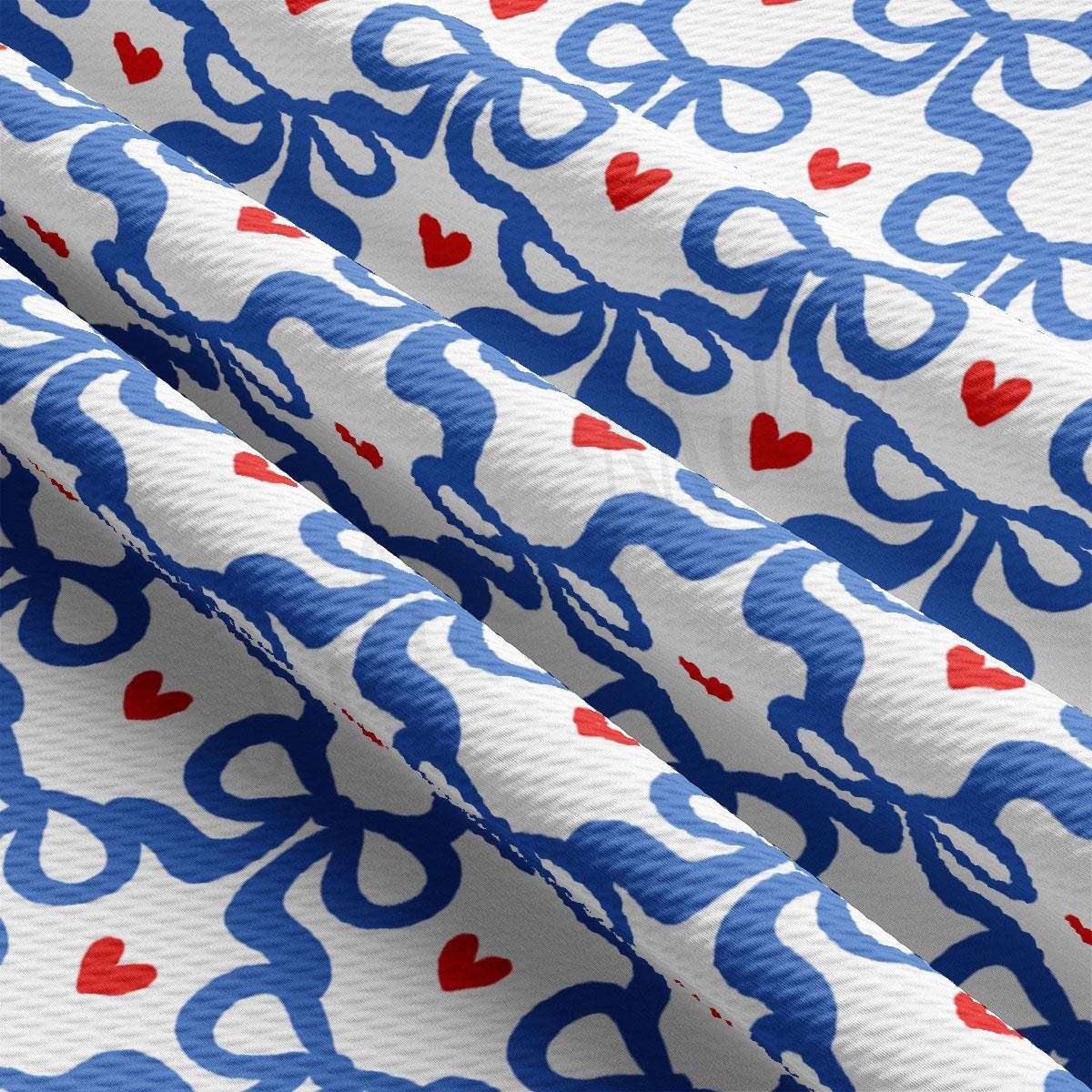a close up of a blue and white fabric with hearts on it