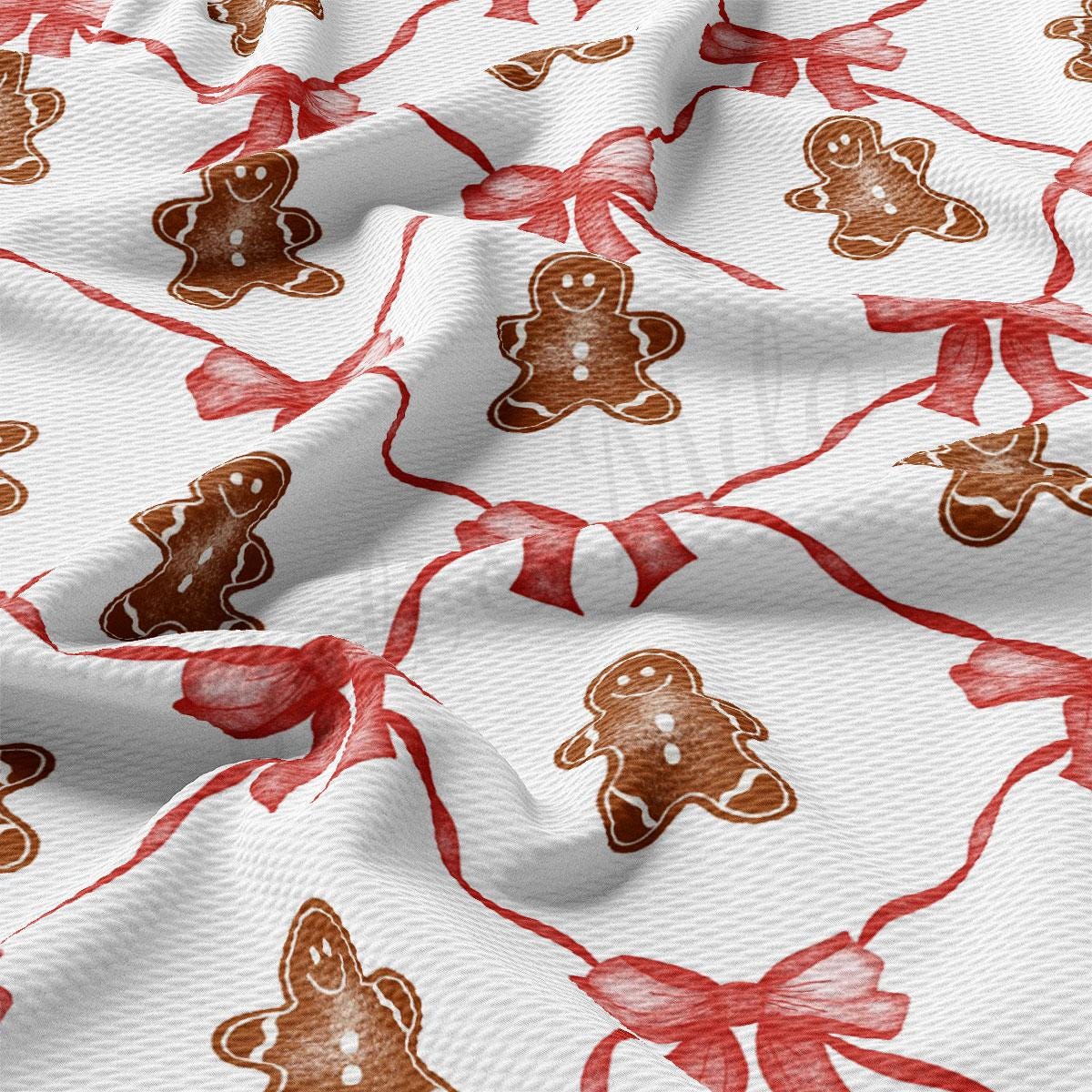 a white fabric with red and brown gingerbreads on it