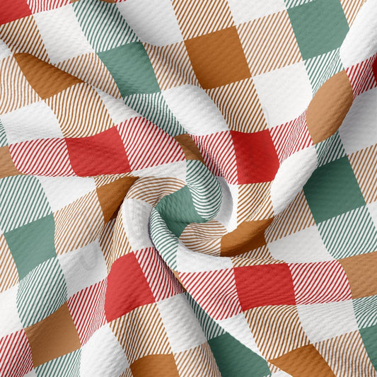 a close-up view of a fabric with a repeating pattern of red, white, and green squares, creating a checkered or plaid design.