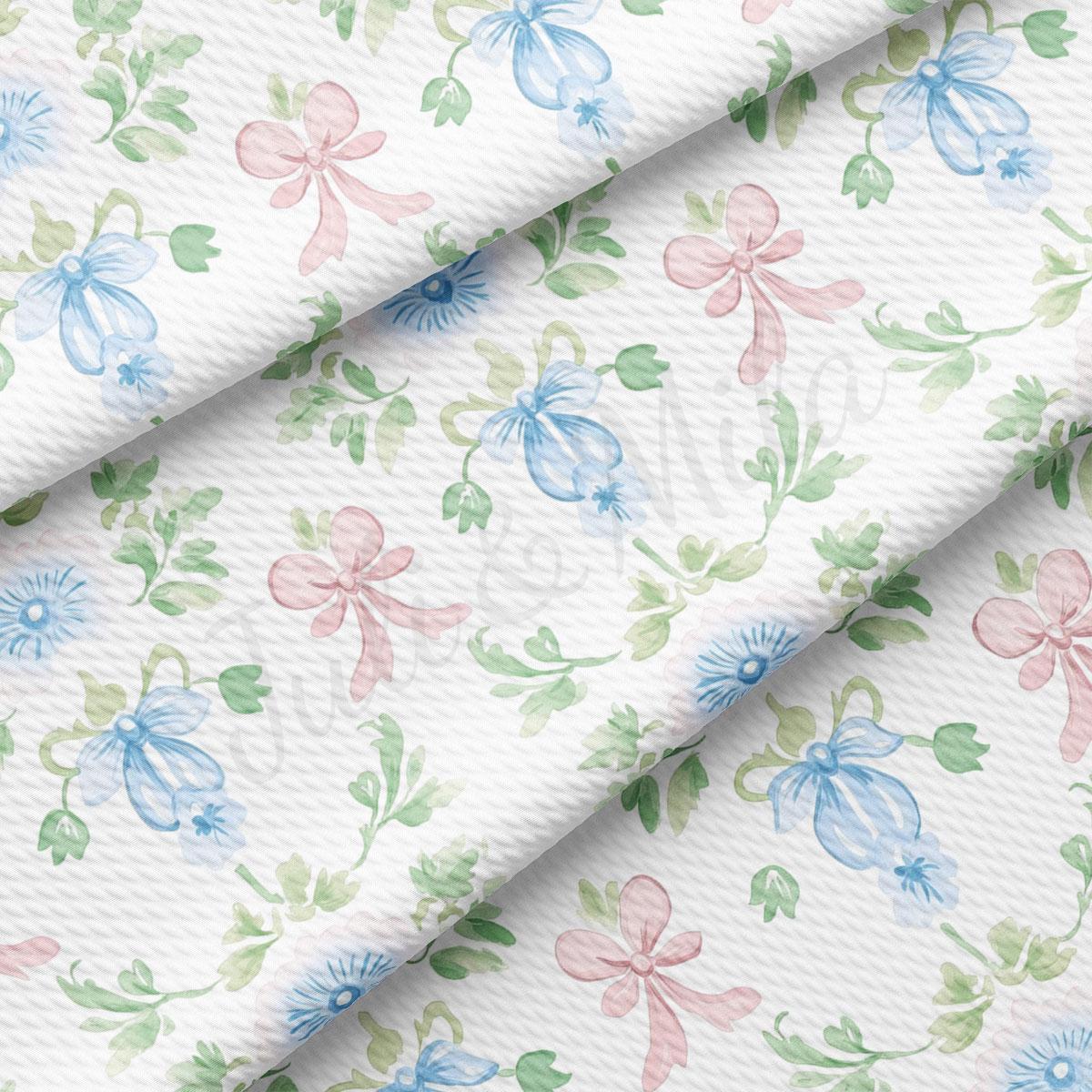 a repeating pattern of blue and pink flowers with green leaves, creating a visually appealing and harmonious design.