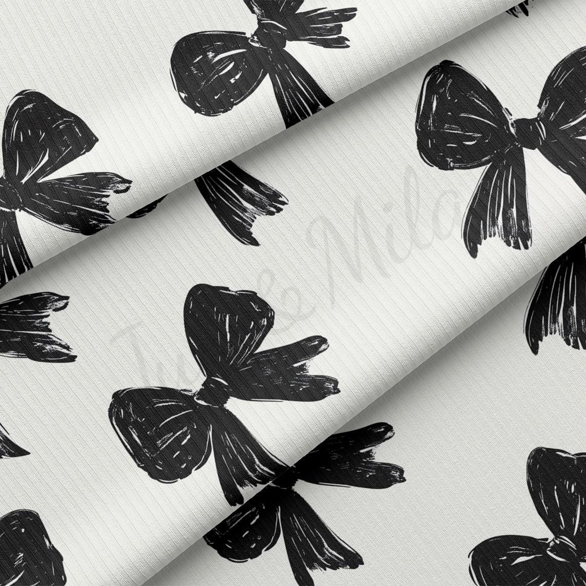 a repeating pattern of black bows on a white background.