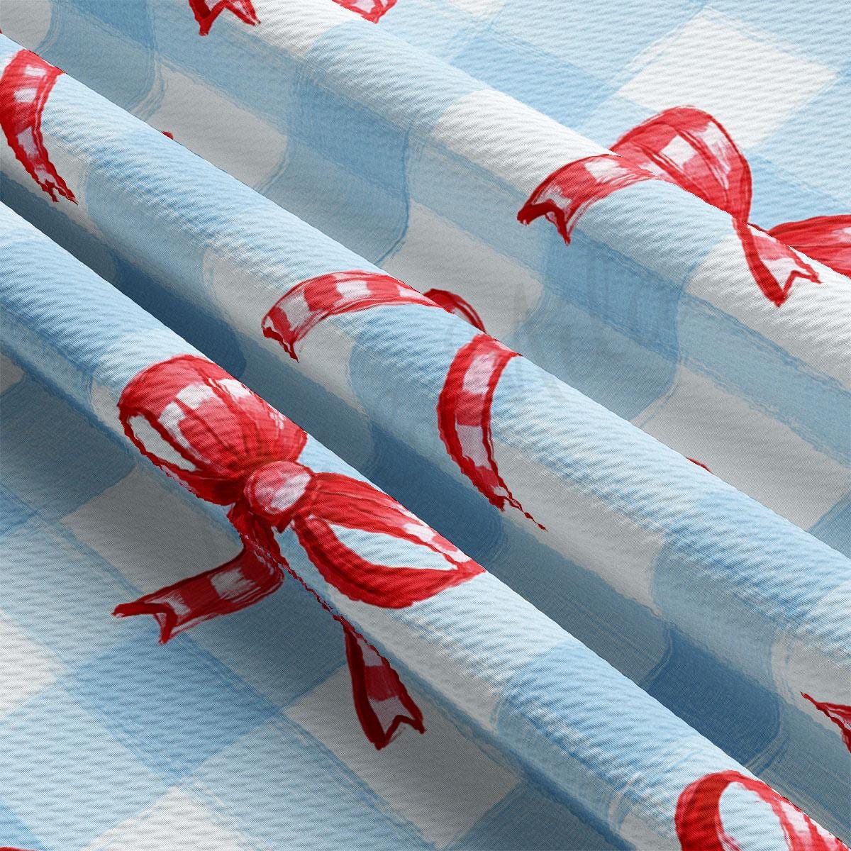 a blue and white checkered table cloth with red bows