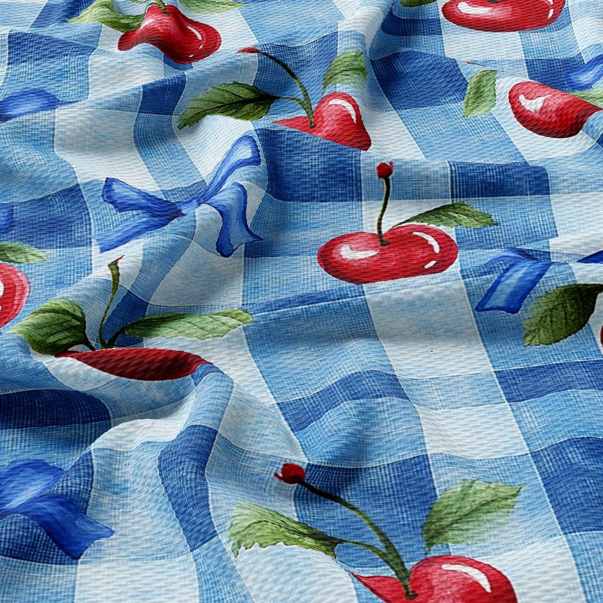 a blue and white checkered fabric with cherries on it