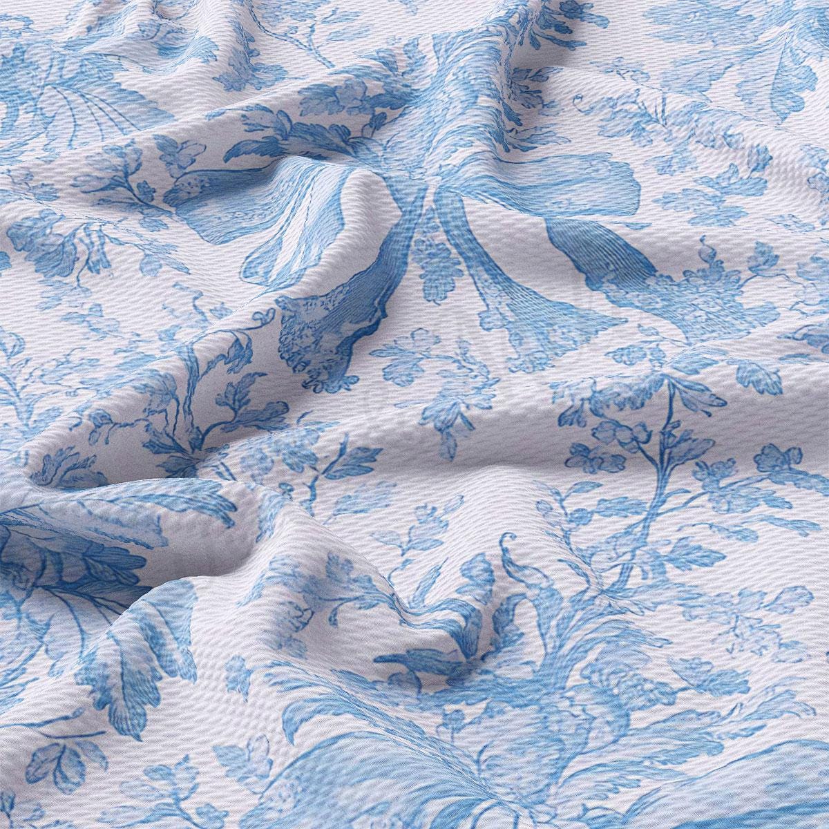 a close-up view of a fabric with a blue floral pattern. The fabric appears to be crumpled and wrinkled, giving it a textured and soft appearance.