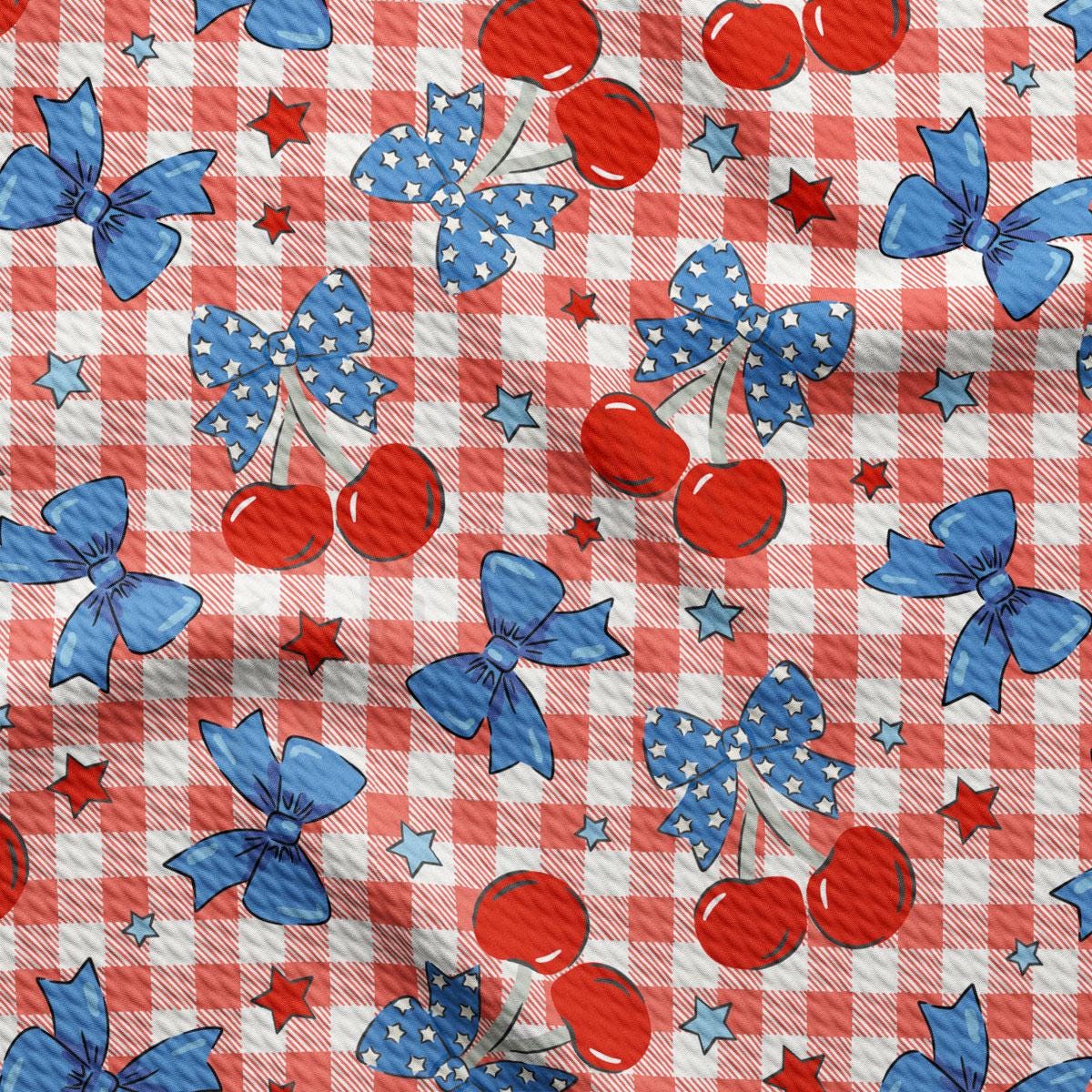 a red, white and blue checkered table cloth with cherries and stars