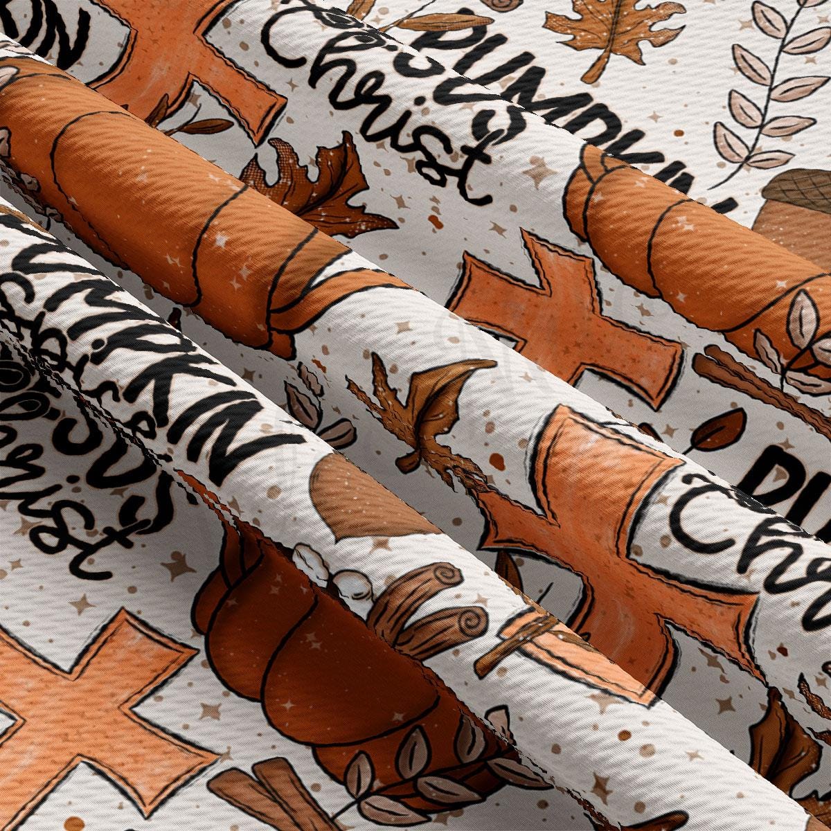 The image is a close-up view of a fabric with a repeating pattern of orange and white autumn-themed elements, including leaves, pumpkins, and crosses. The pattern is visually striking and creates a festive atmosphere.
