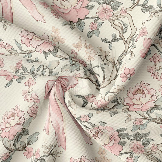 a close-up view of a fabric with a floral pattern, including pink and white flowers and leaves. The fabric appears to be crumpled, giving it a soft and delicate appearance.