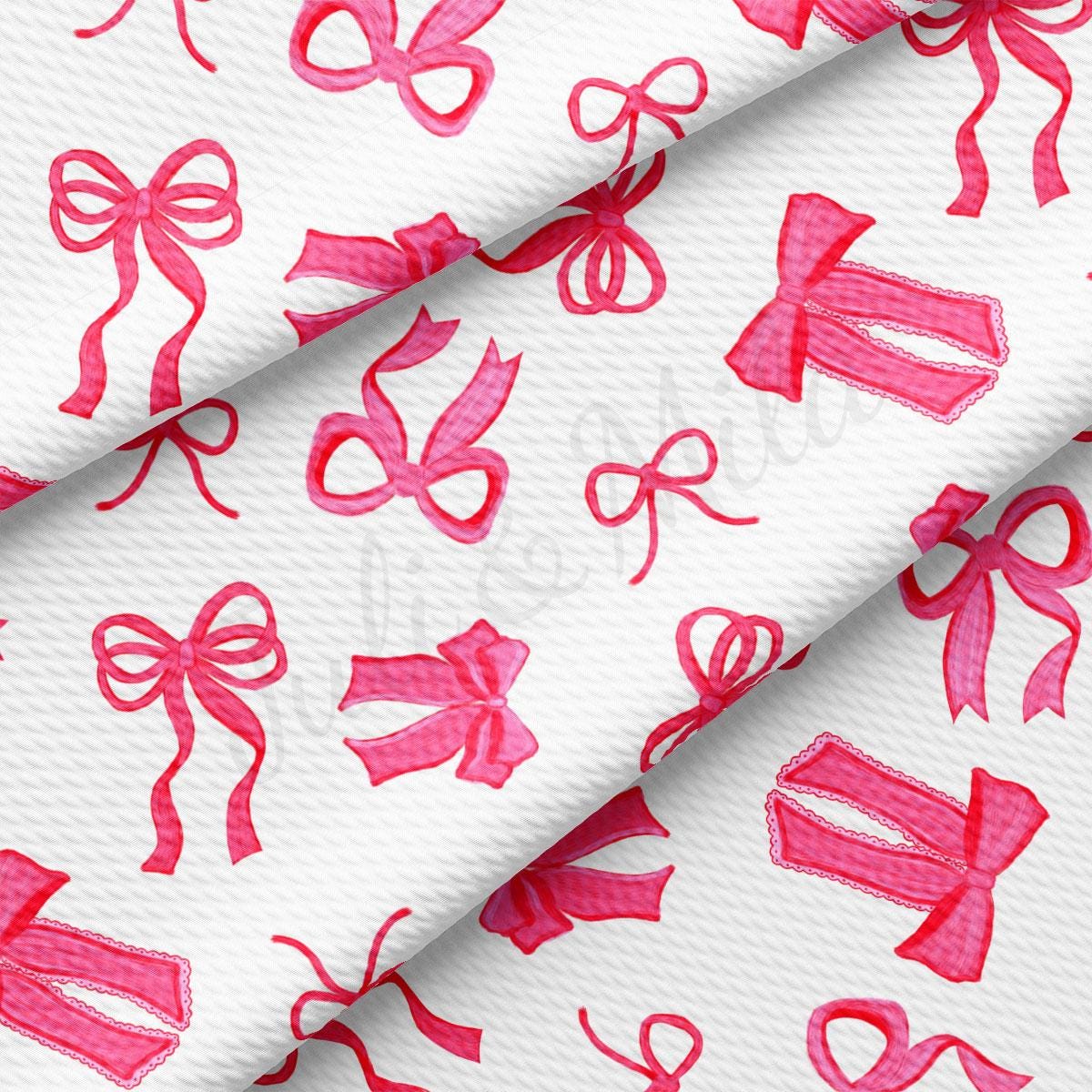 a close up of a pink ribbon on a white background