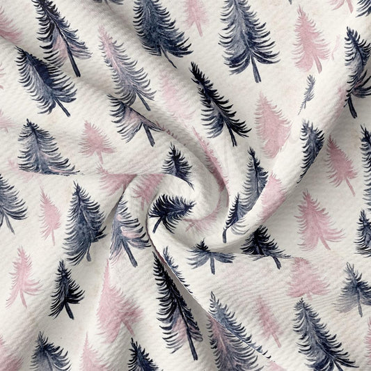 a close-up view of a fabric with a repeating pattern of stylized pine trees in shades of pink and blue.