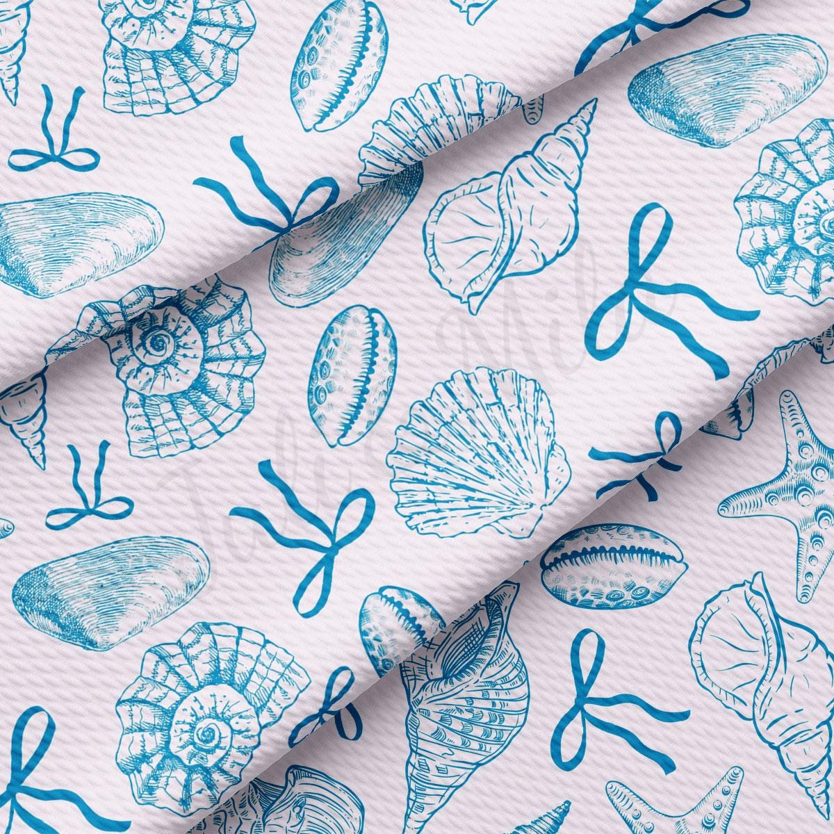 a blue and white pattern of seashells on a white background