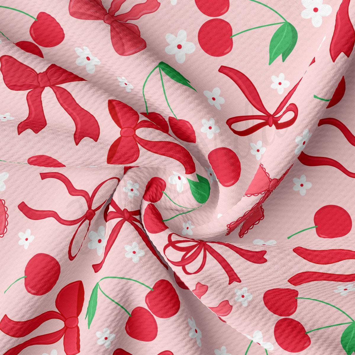 a close up of a pink fabric with cherries on it