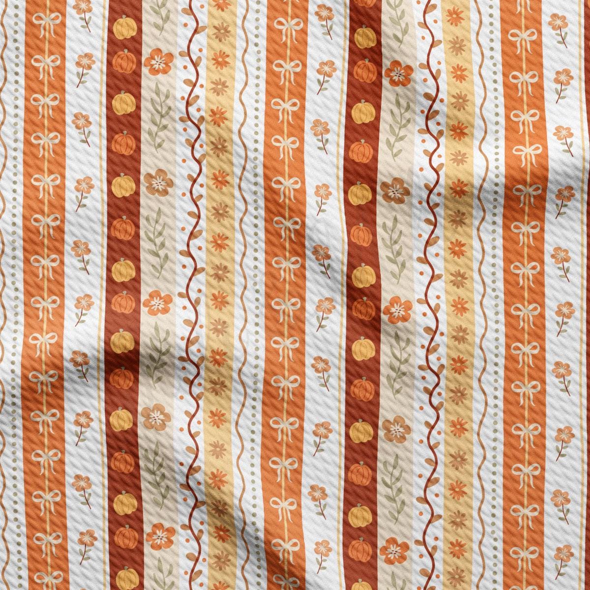 a repeating pattern of orange and white stripes with floral and pumpkin designs.
