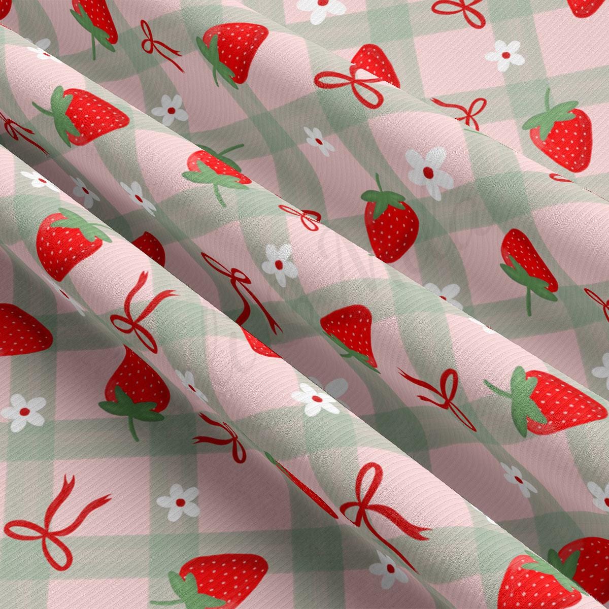 a pink and green checkered fabric with strawberries on it