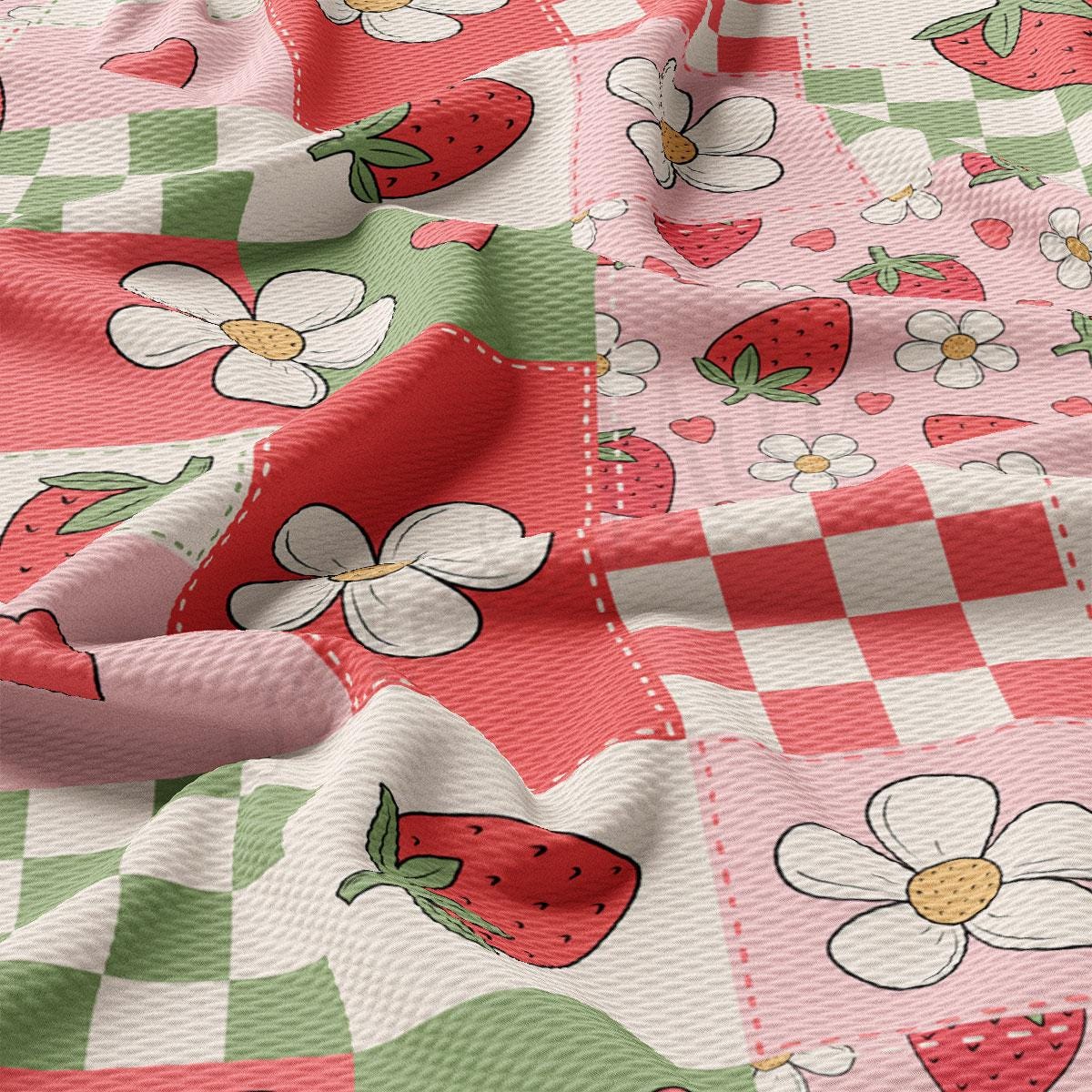 a pink and green checkered fabric with strawberries on it