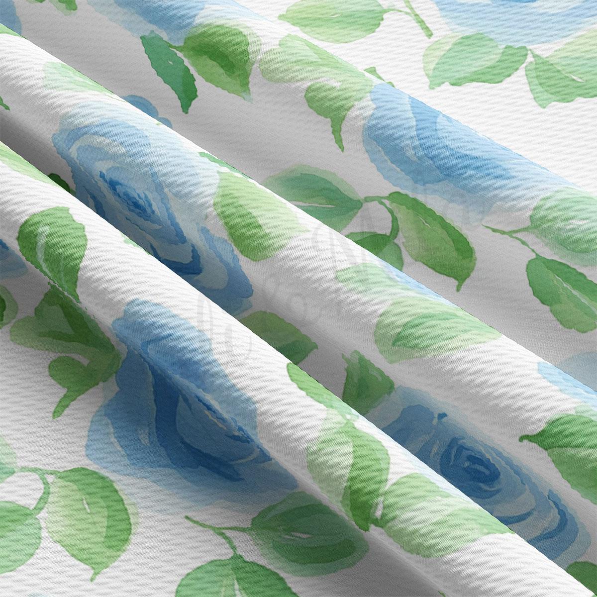 a close-up view of a fabric with a floral pattern of blue and green leaves.