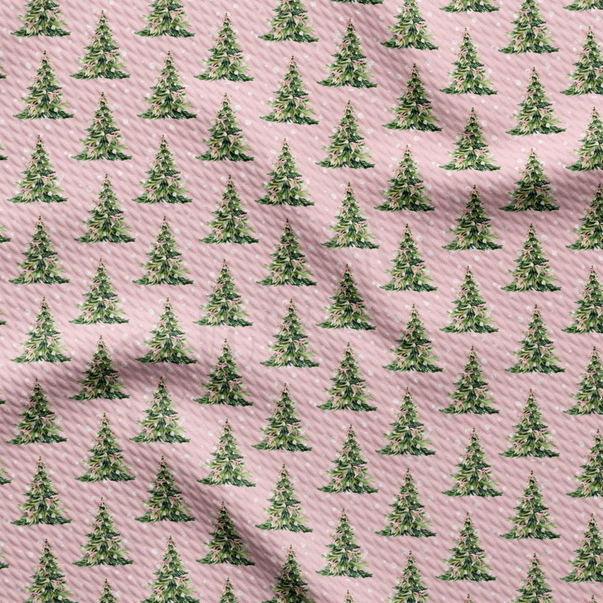 a repeating pattern of green Christmas trees on a pink background.
