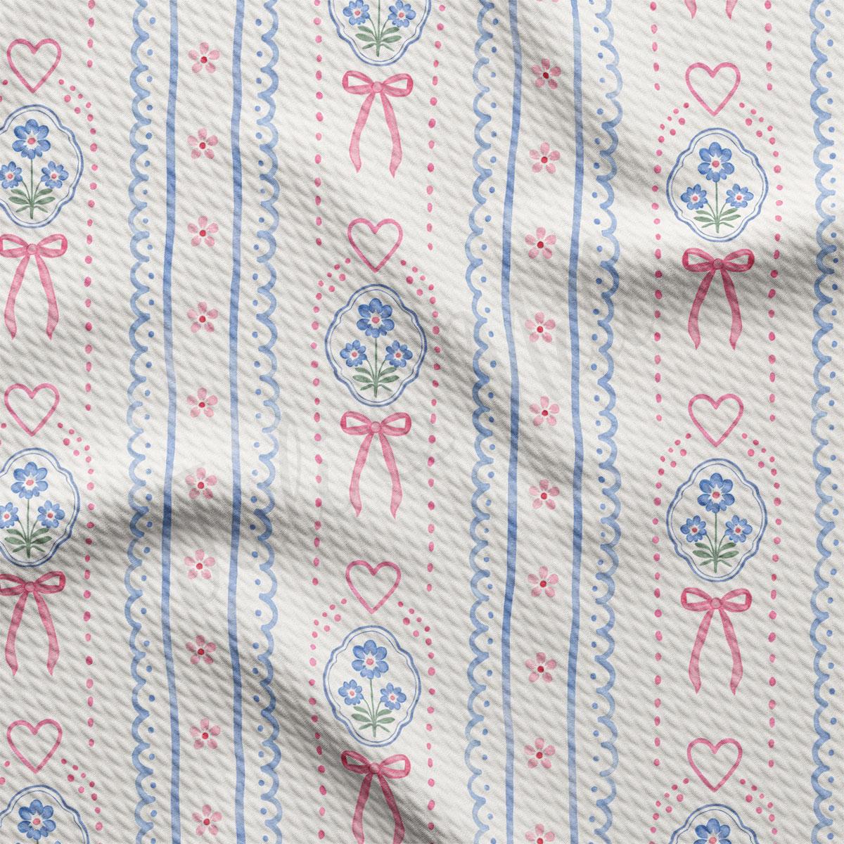 a close-up view of a fabric with a repeating pattern of pink and blue flowers, hearts, and bows. The pattern is composed of vertical lines and curves, creating a textured and visually appealing design.